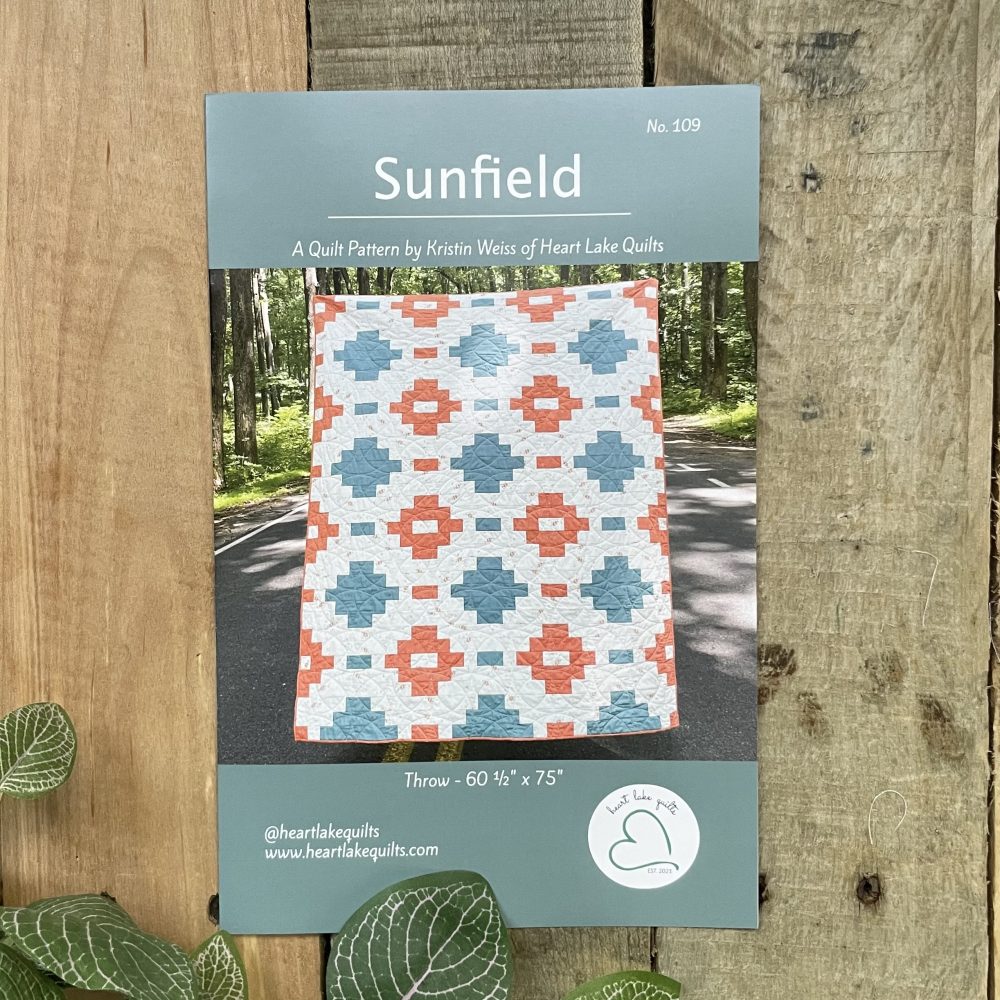 Sunfield quilt pattern cover with teal coral design