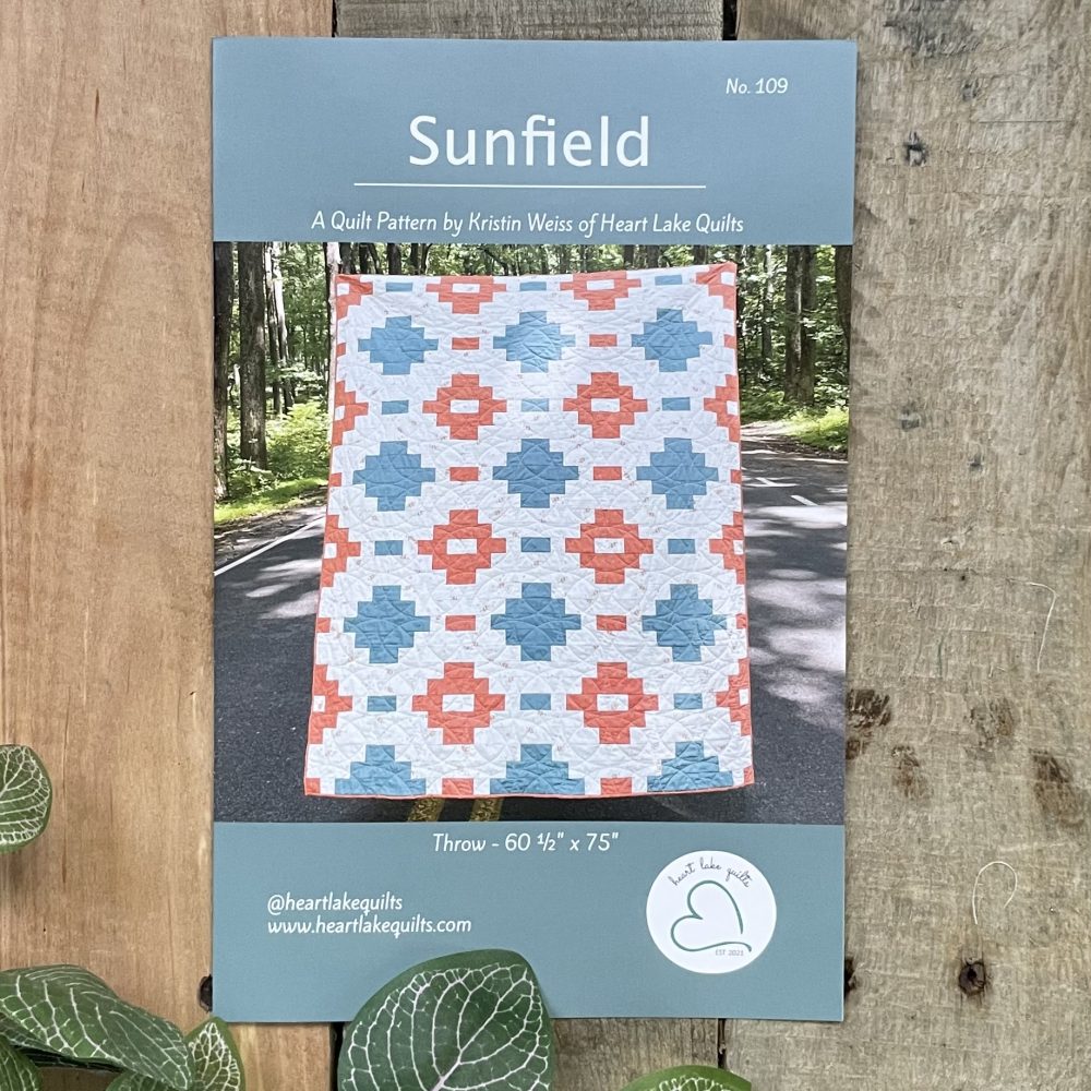 Sunfield quilt pattern cover with blue and coral design