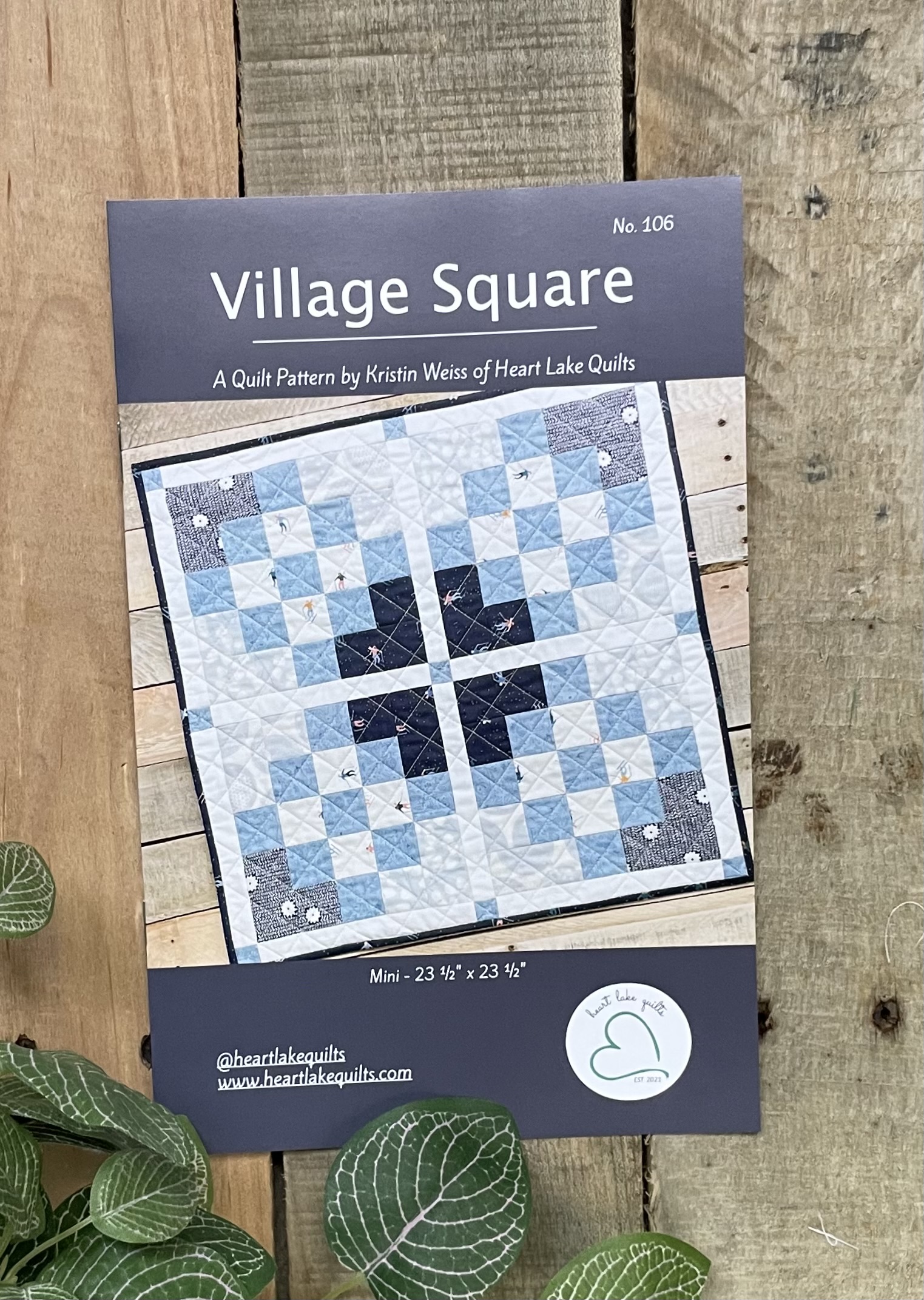 Village Square quilt pattern cover with blue design