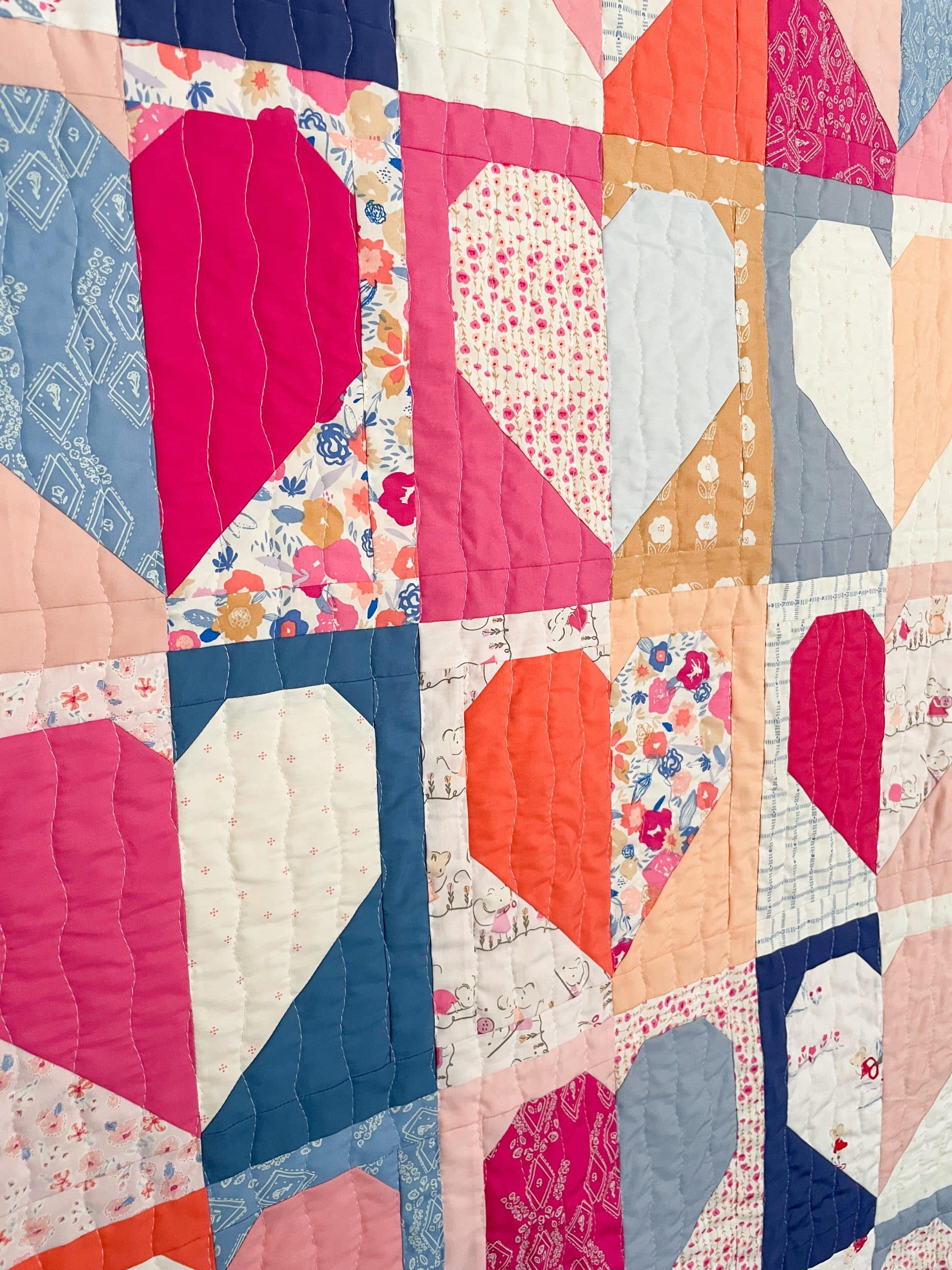 Colorful patchwork quilt with heart patterns.