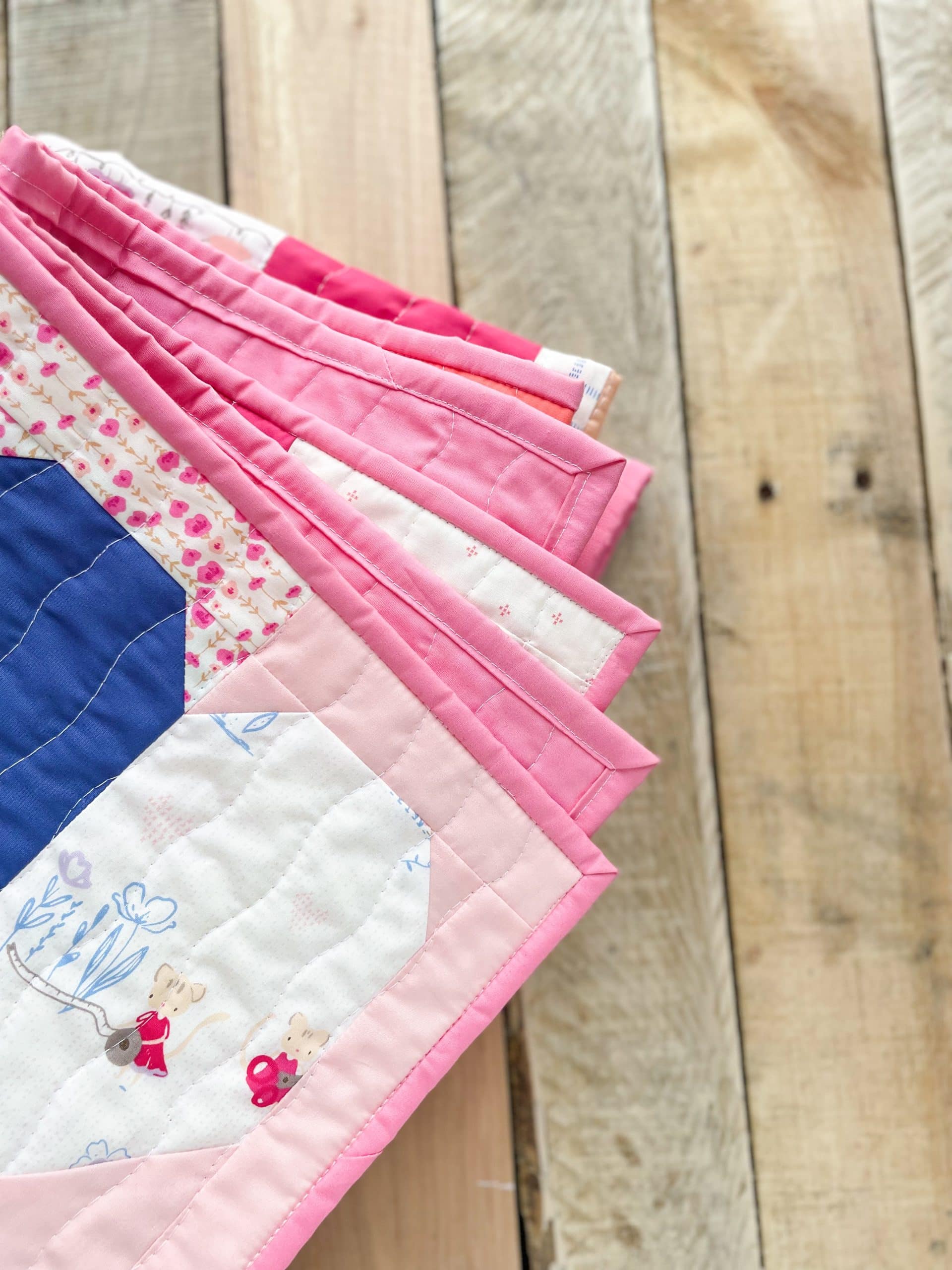 Colorful quilt edges on wooden surface