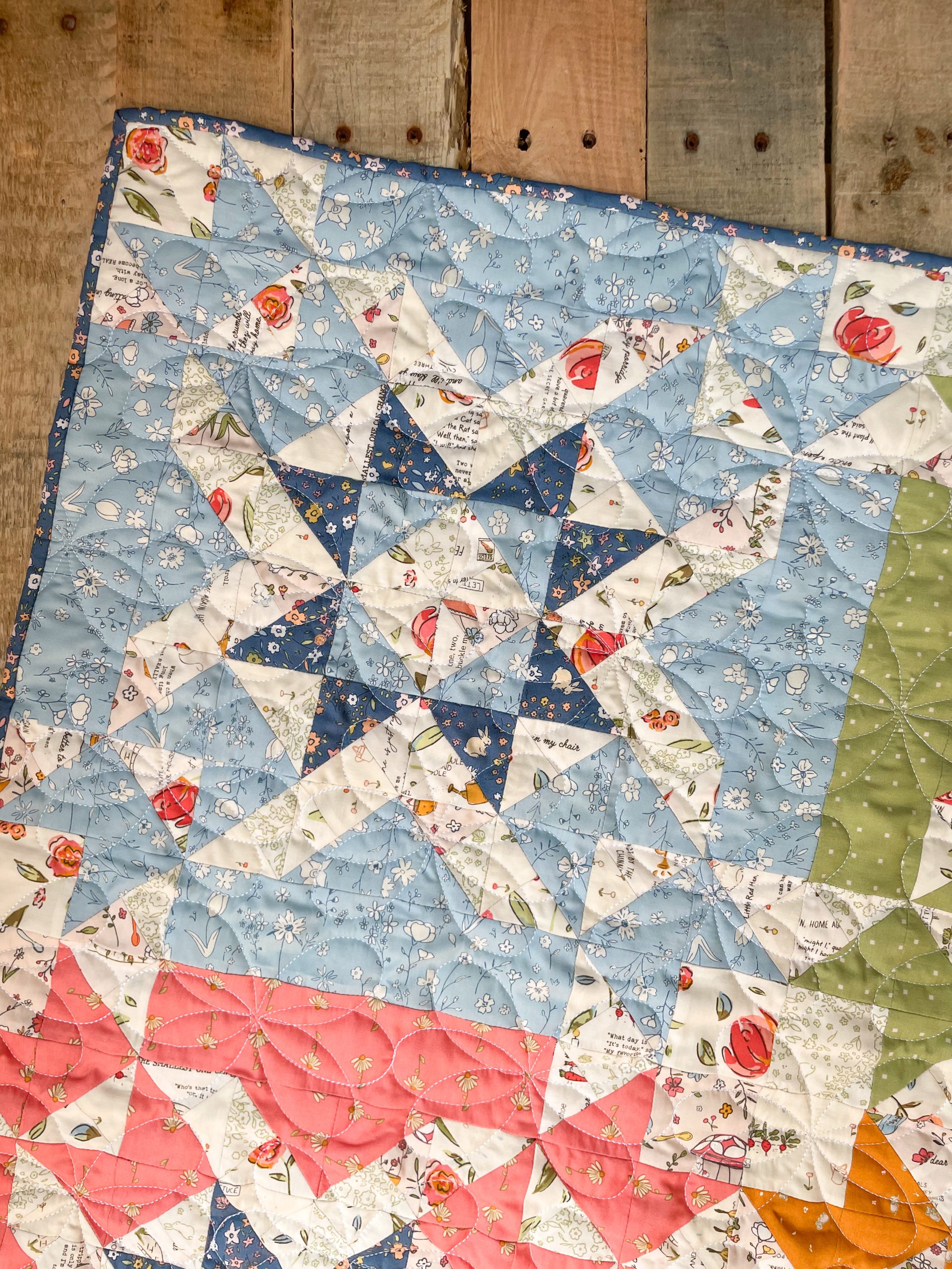Colorful star-patterned quilt on wooden background.