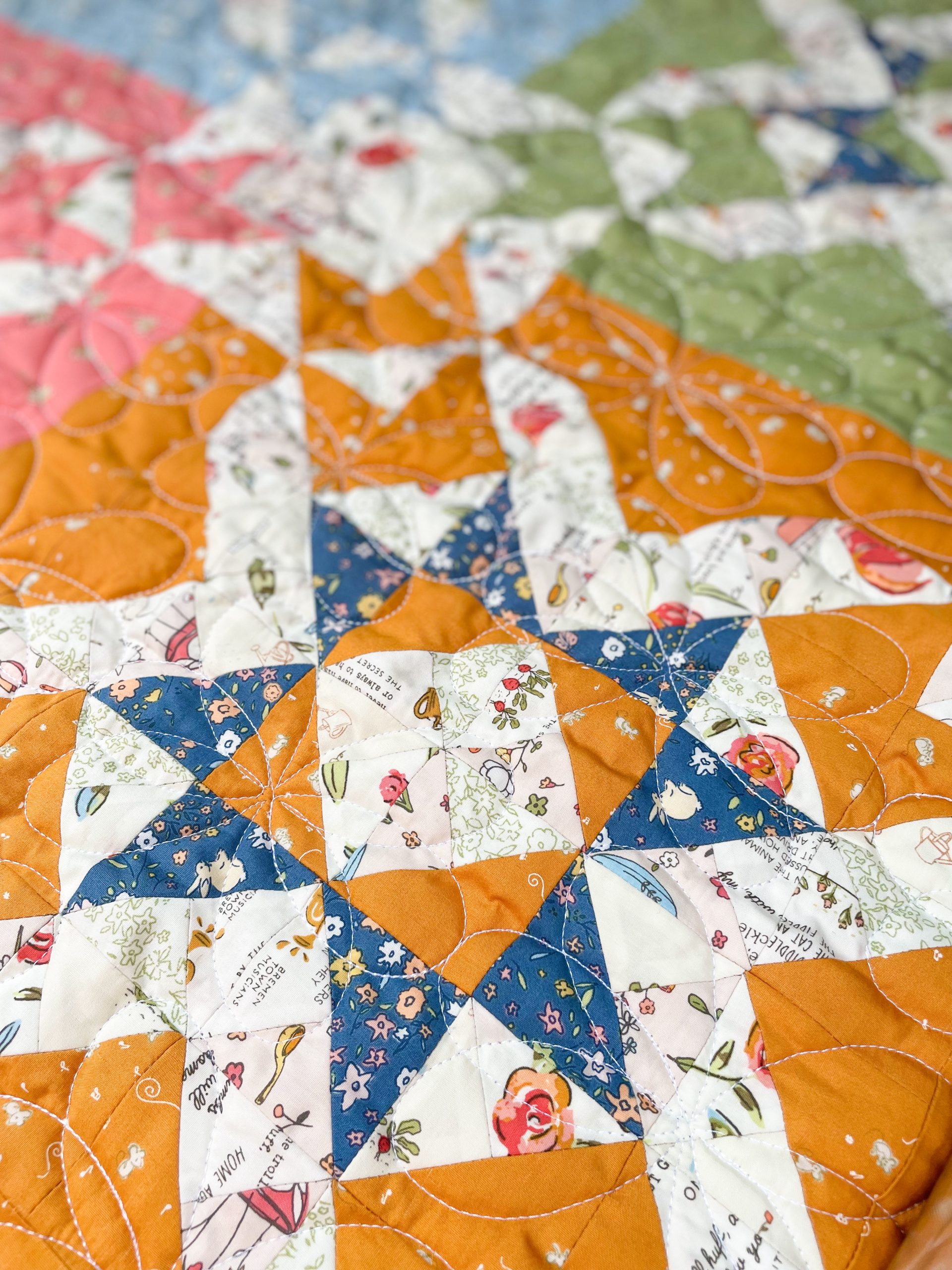 Colorful patchwork quilt with floral and geometric patterns.