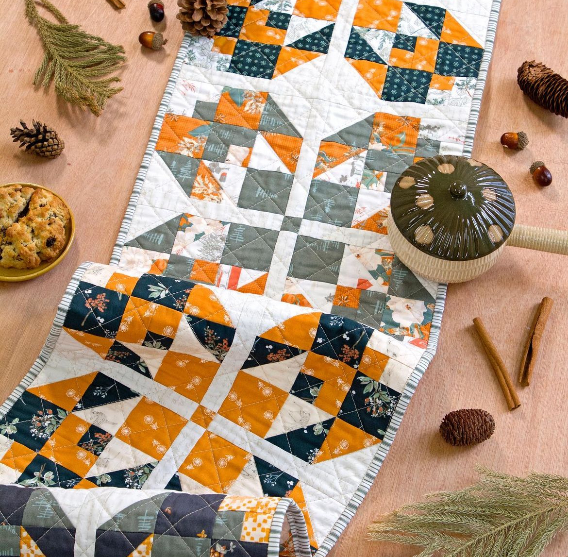 Autumn quilted table runner with pinecones and teapot