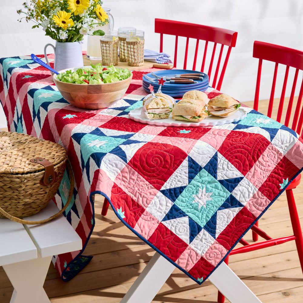 Colorful quilted tablecloth on outdoor picnic setup