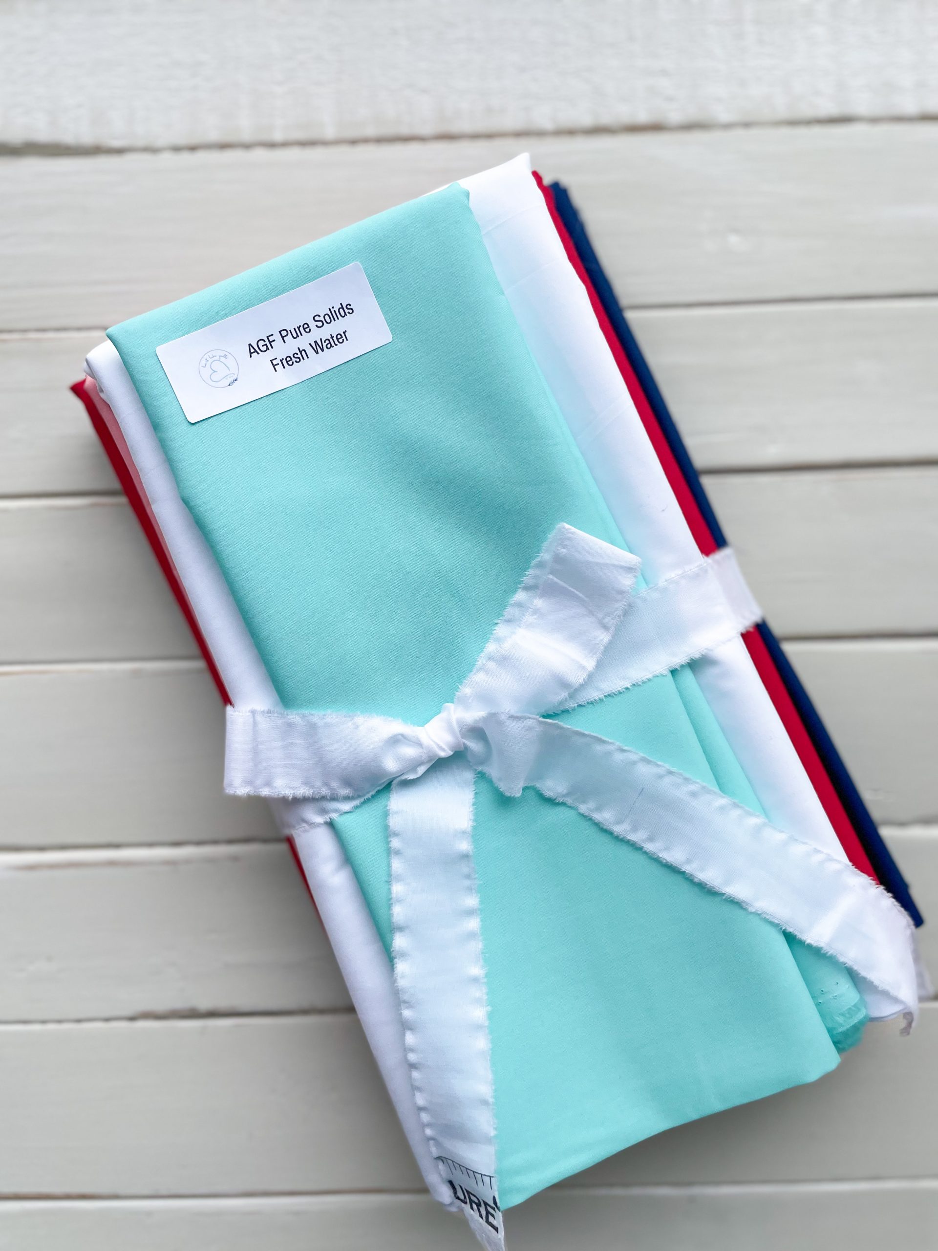 Stack of colorful fabric with ribbon