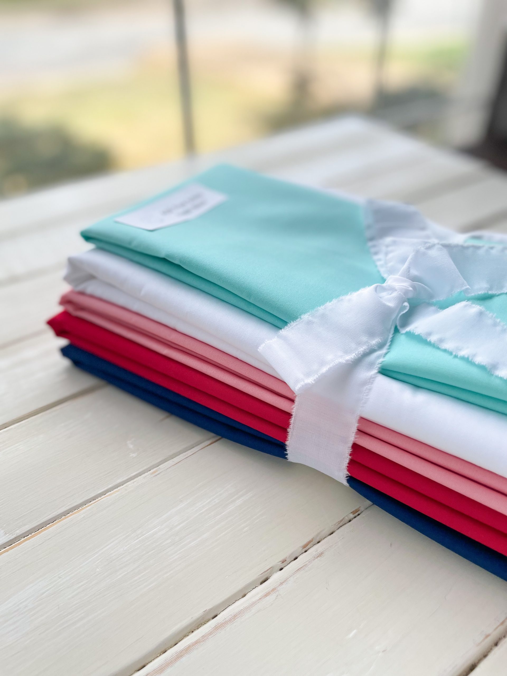 Colorful fabric stack tied with ribbon