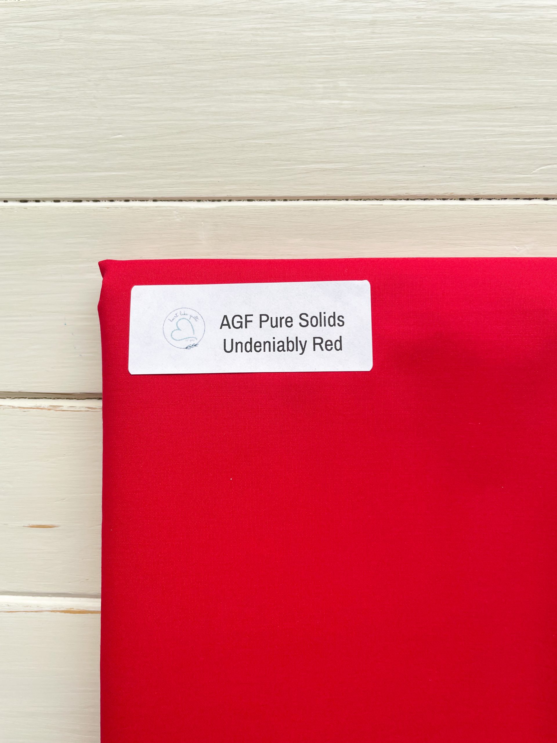 Red fabric labeled 'AGF Pure Solids'
