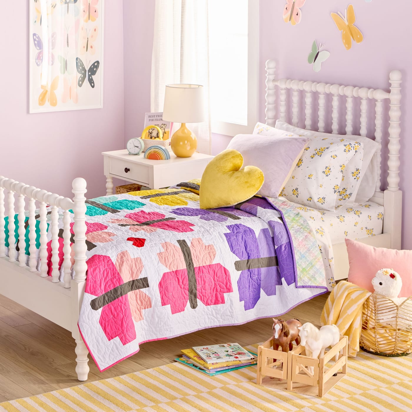 Pastel kids bedroom with butterfly quilt and decor