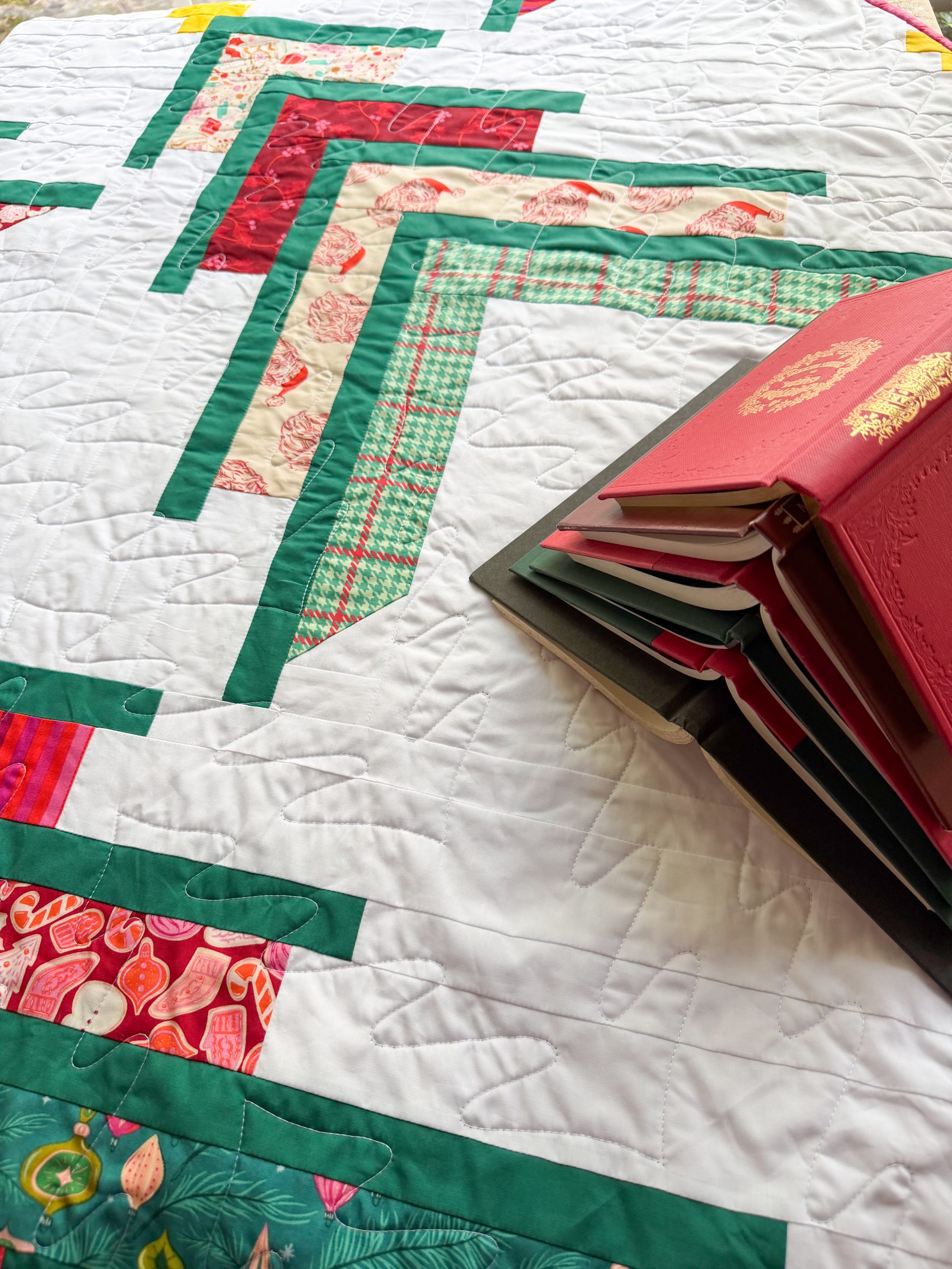 Stack of books on festive quilt