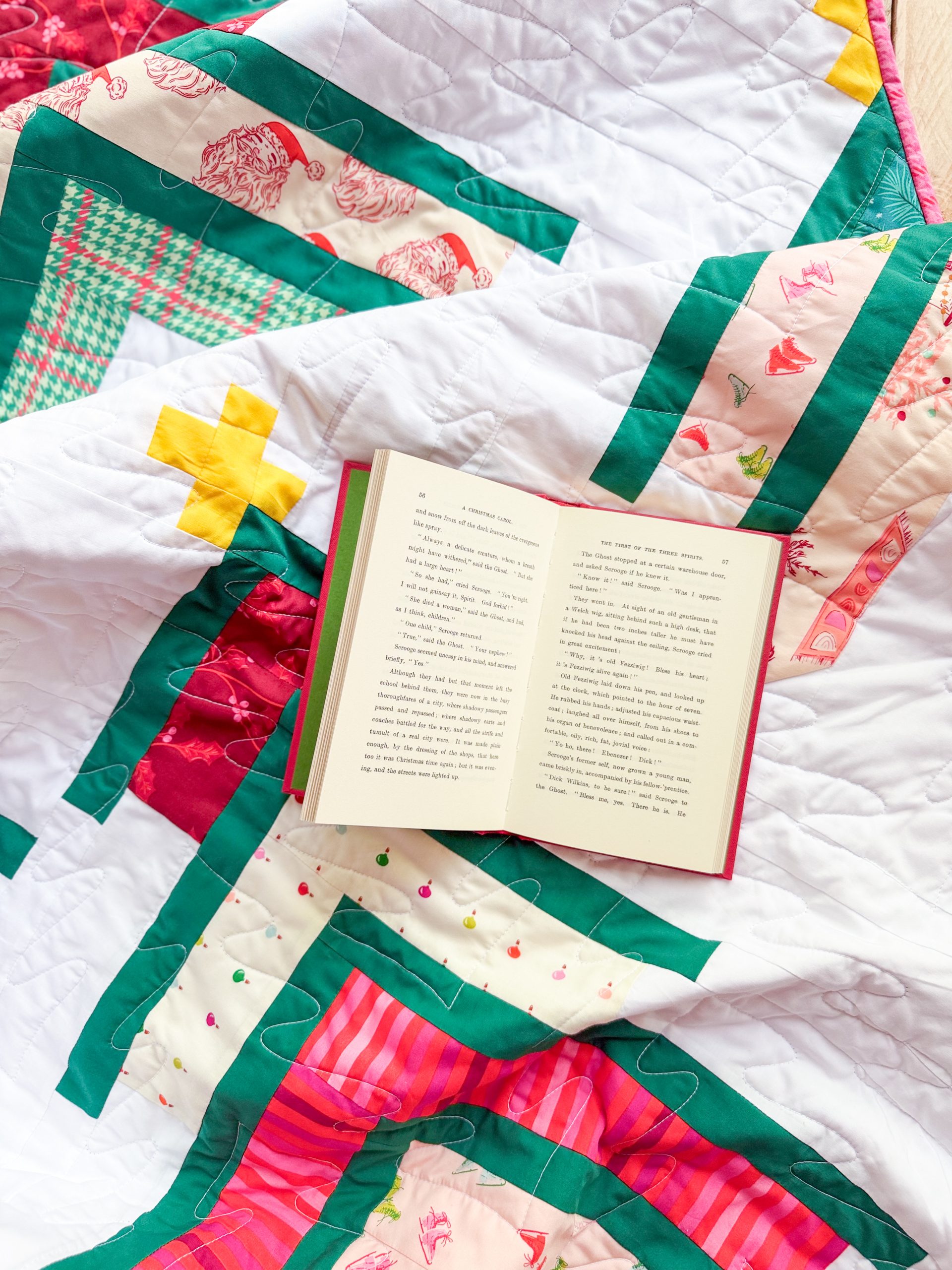 Open book on colorful Christmas patchwork quilt