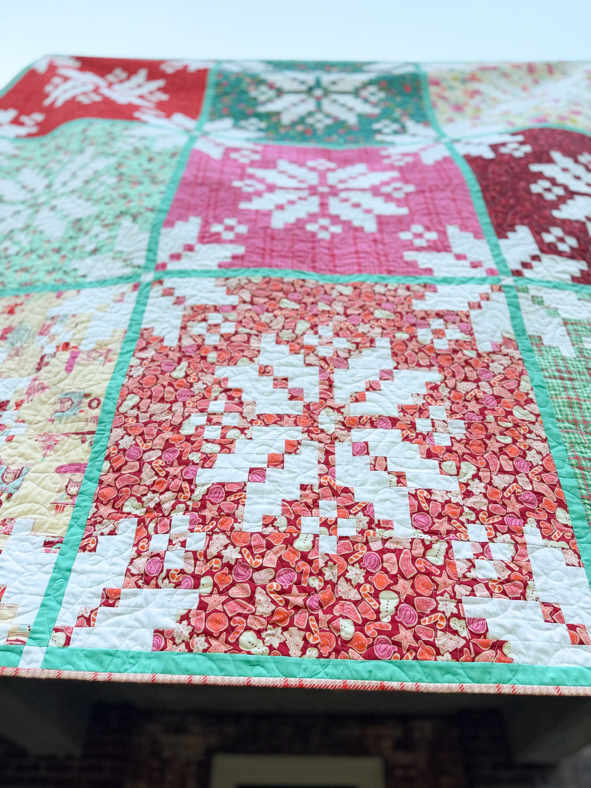 Colorful holiday patchwork quilt with snowflake patterns