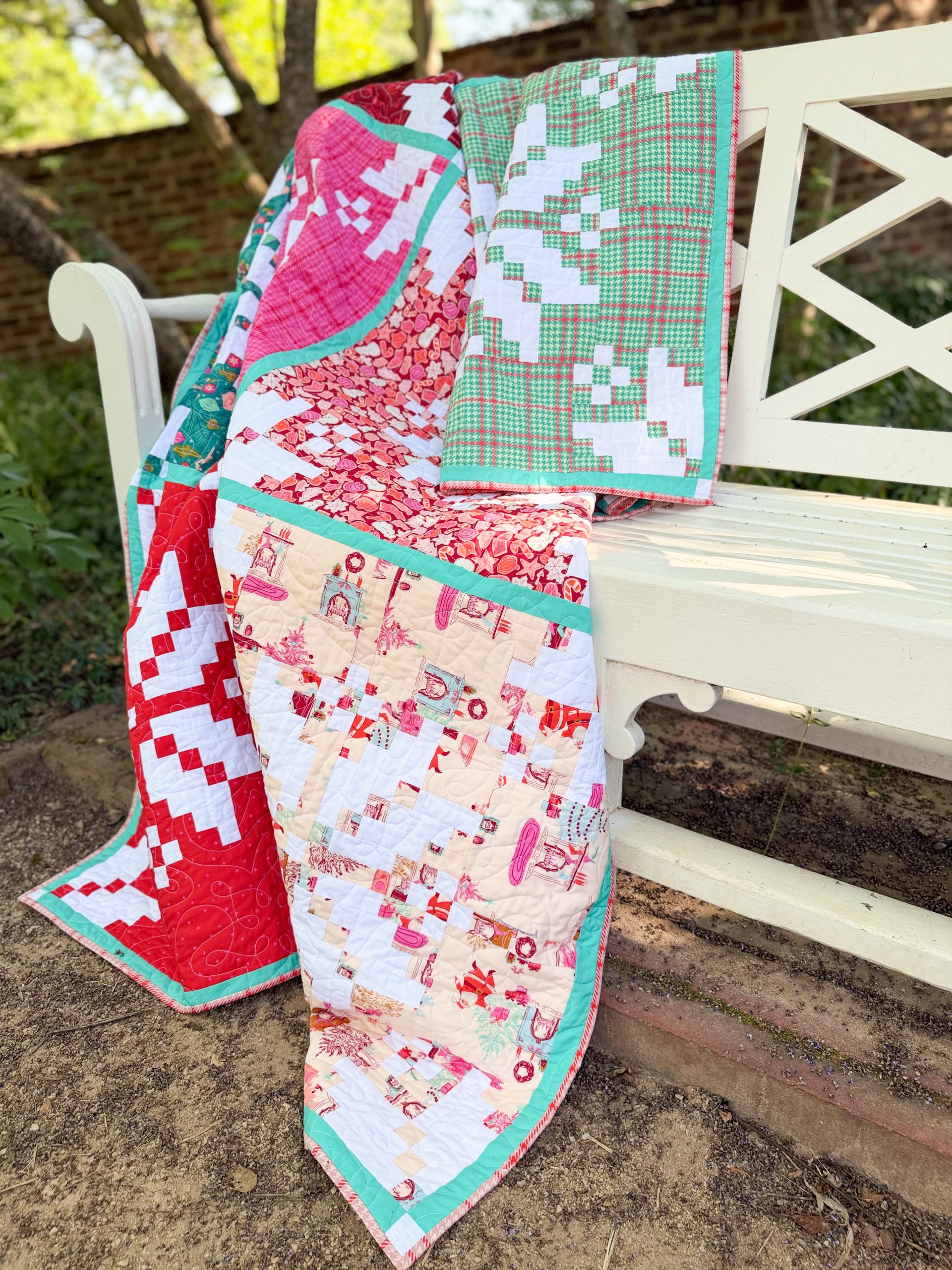 Colorful patchwork quilt draped over white bench