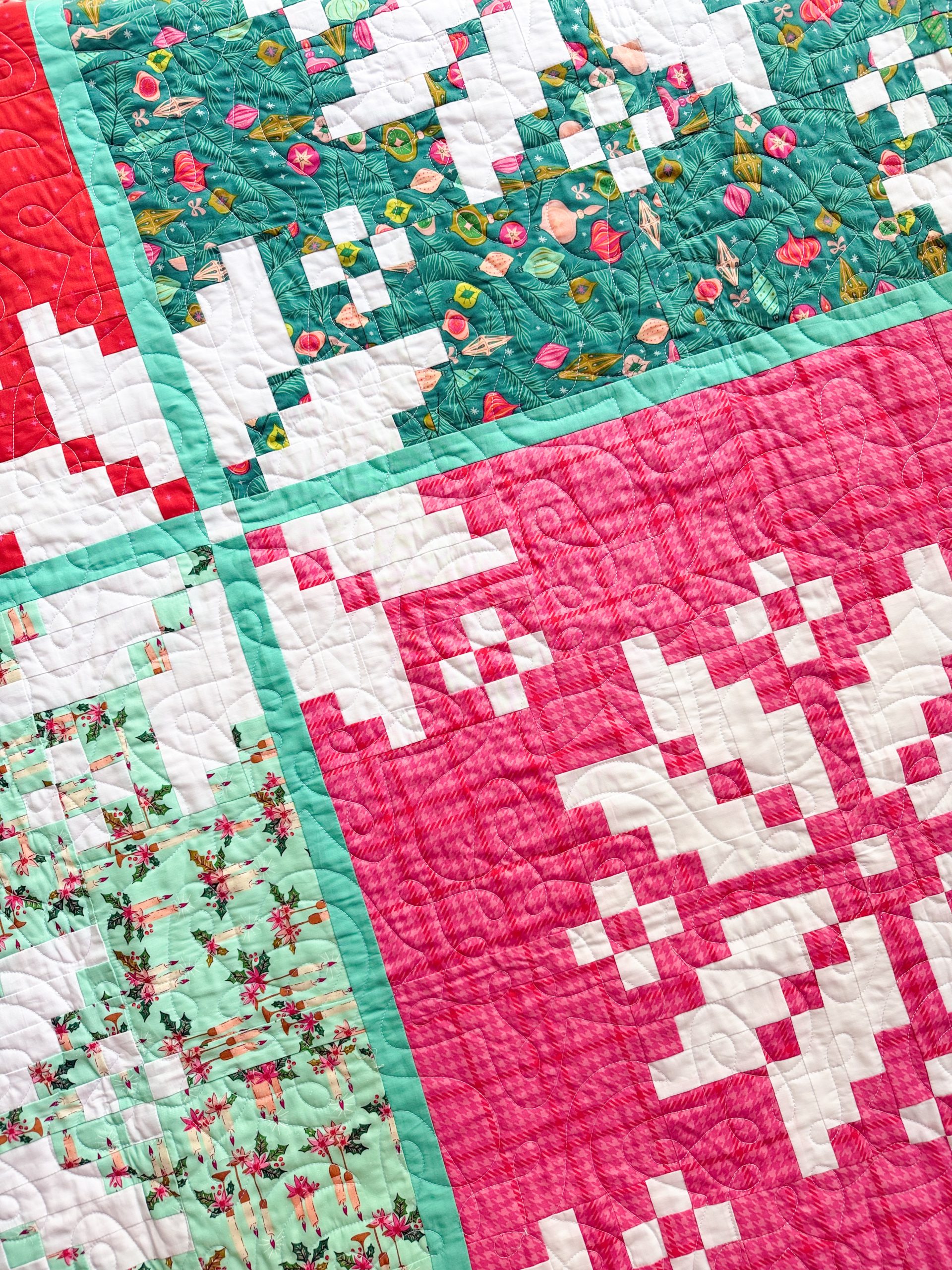 Colorful patchwork quilt with teal and pink blocks
